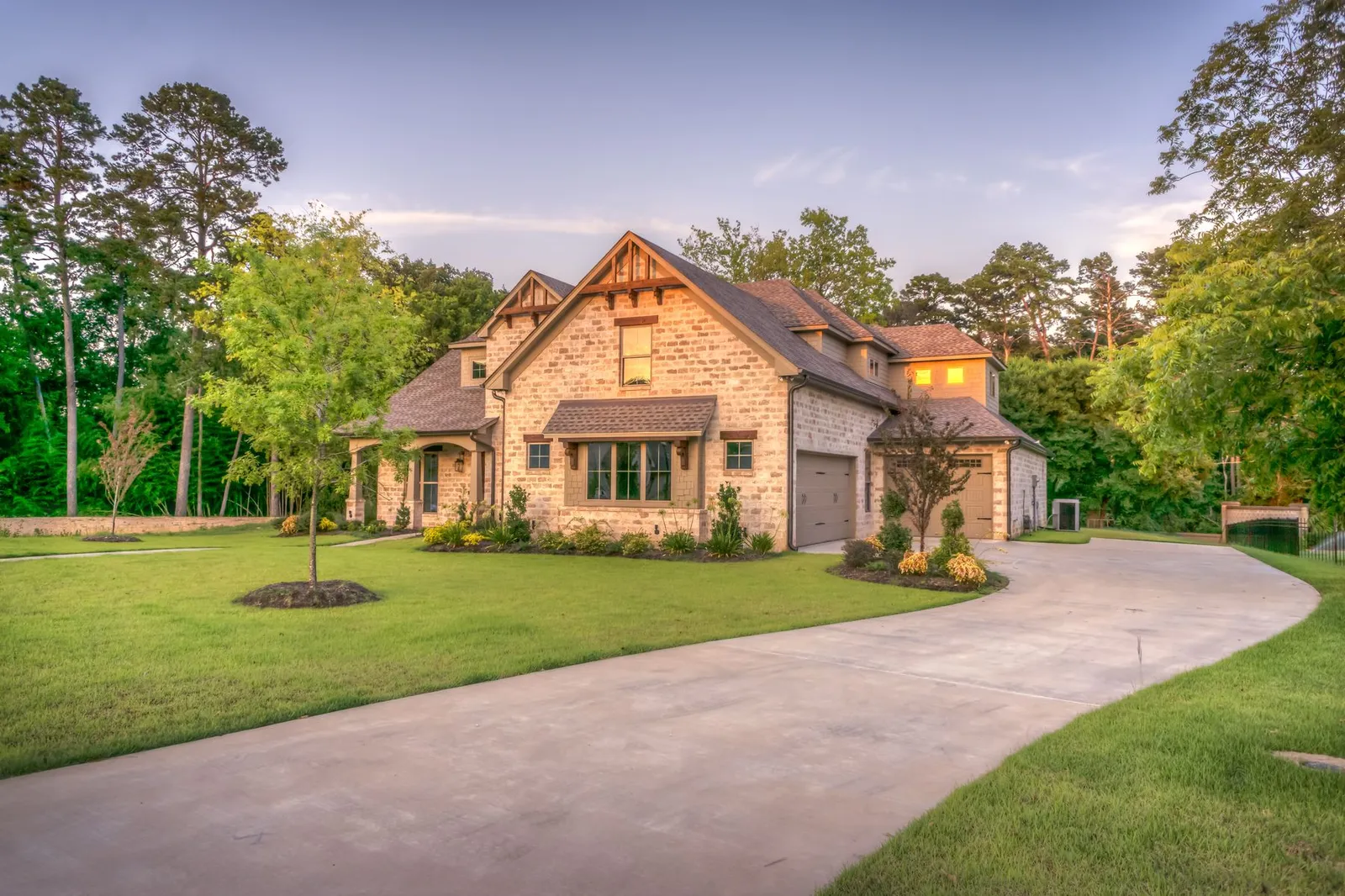 Stone and siding family home with a long driveway