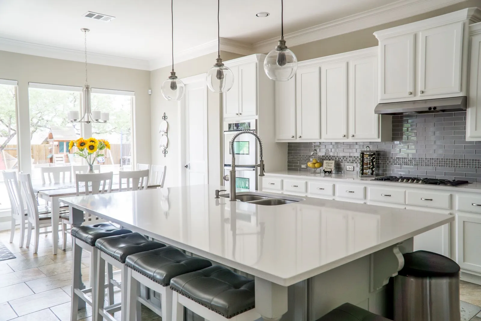 Renovated kitchen with island seating and white cabinetry