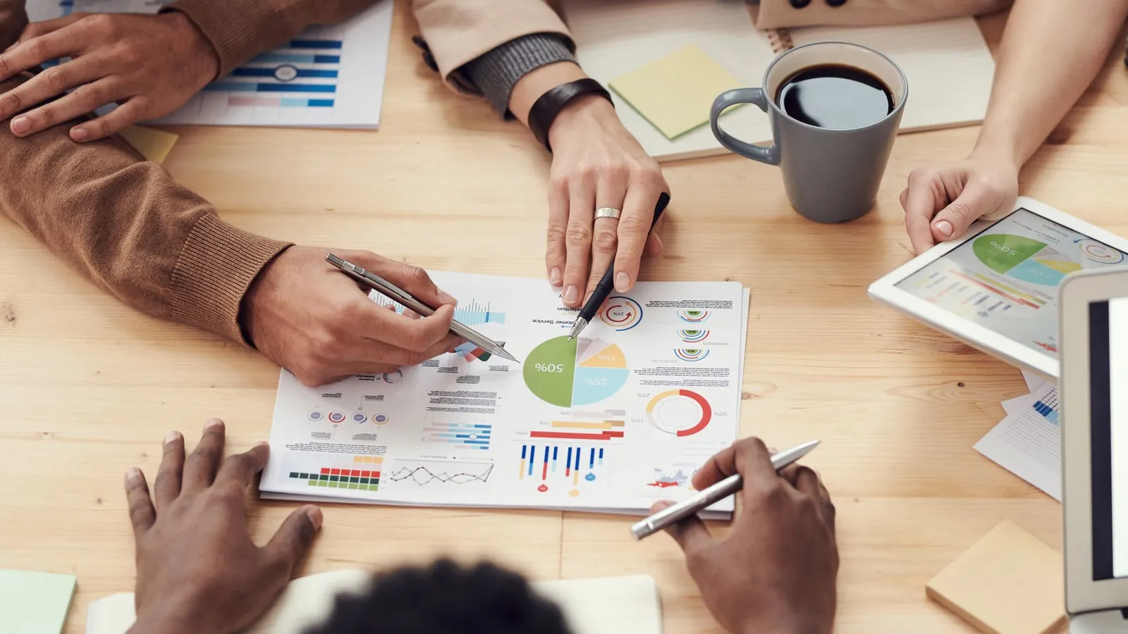 Team reviewing cost charts and budget figures at a table