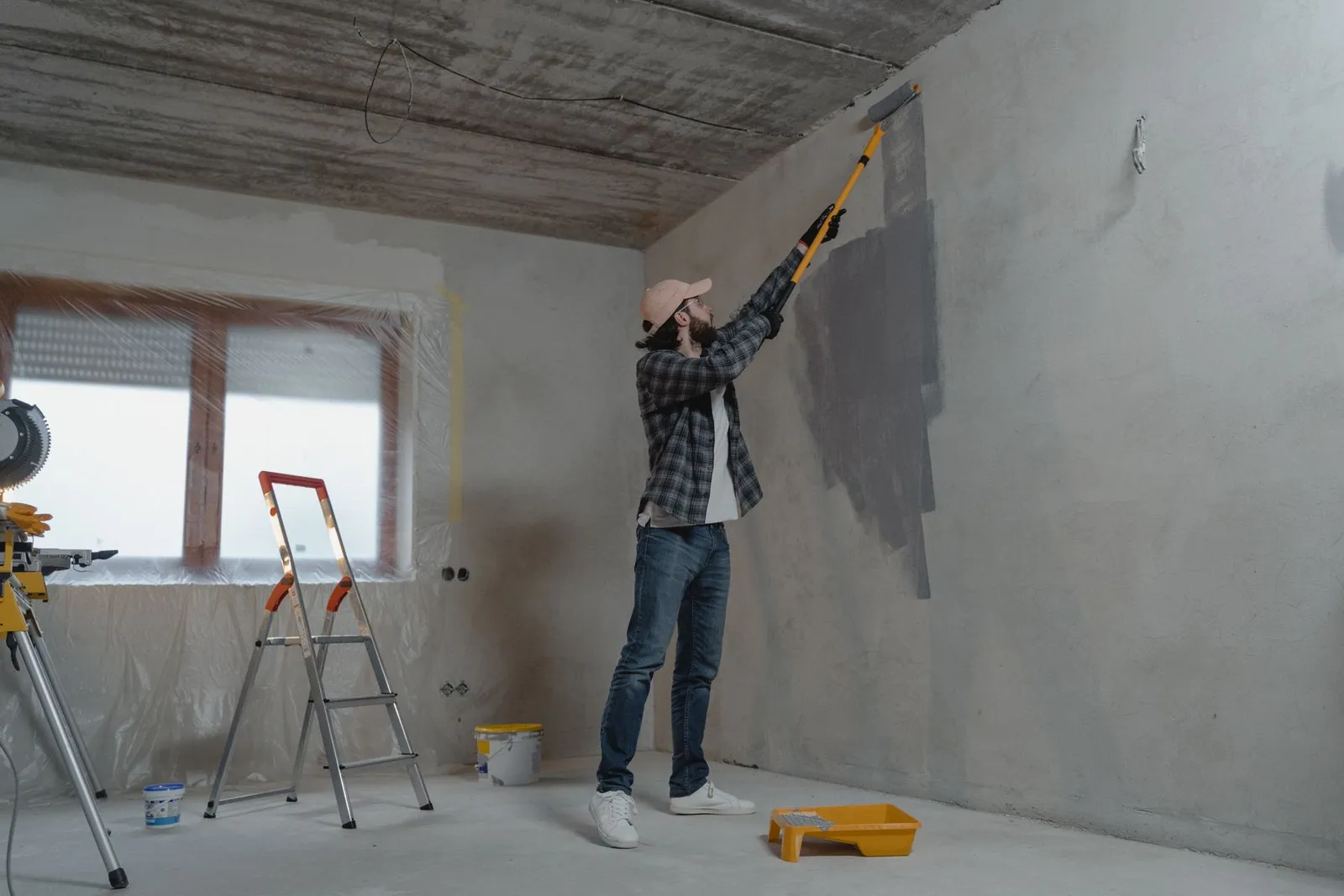 Tradesman finishing a ceiling during a renovation